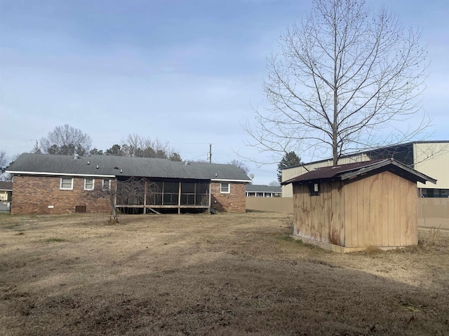 back of property with a sunroom