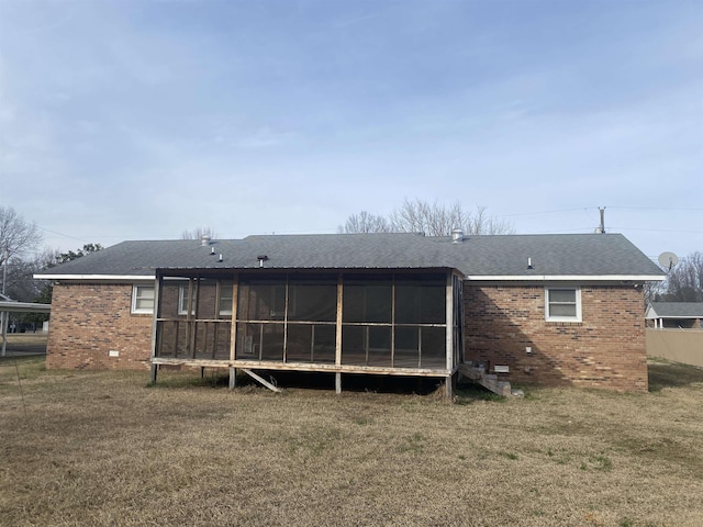 back of house with a sunroom and a lawn