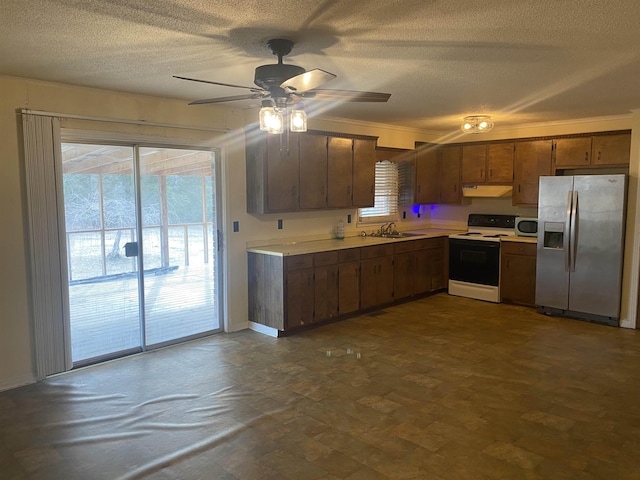 kitchen featuring ceiling fan, stainless steel appliances, a textured ceiling, crown molding, and sink