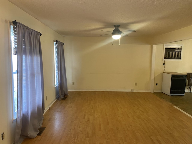 unfurnished living room with a textured ceiling, ceiling fan, and wood-type flooring