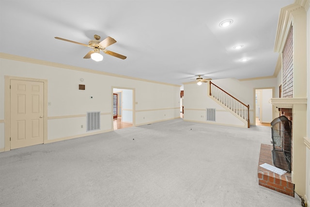 unfurnished living room with a brick fireplace, light colored carpet, ornamental molding, and ceiling fan