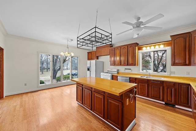 kitchen with wood counters, sink, hanging light fixtures, white gas range oven, and fridge with ice dispenser