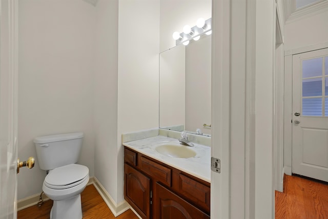 bathroom with vanity, hardwood / wood-style floors, and toilet