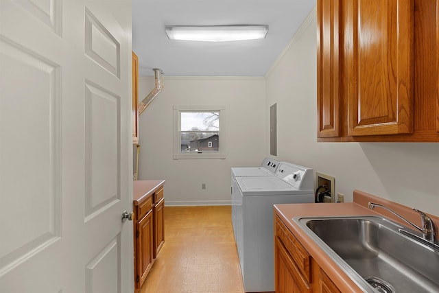 laundry area featuring washer and dryer, sink, cabinets, electric panel, and crown molding