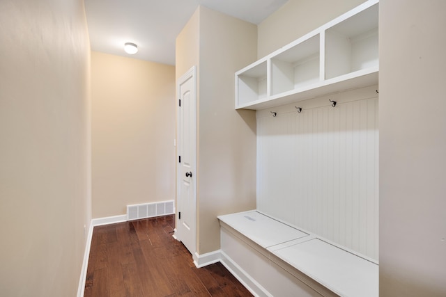 mudroom featuring dark wood-style floors, baseboards, and visible vents