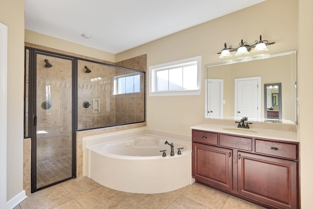 bathroom featuring a stall shower, tile patterned flooring, a bath, and vanity