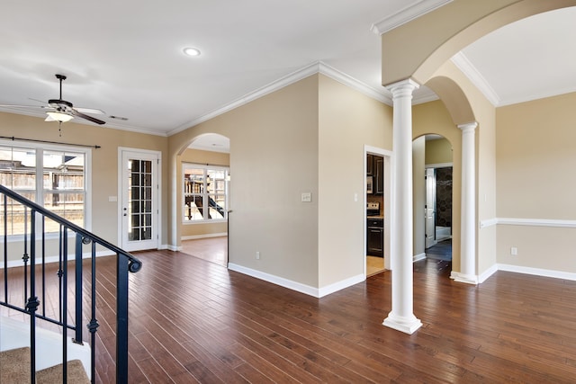 entrance foyer with crown molding, dark wood-style flooring, decorative columns, and baseboards