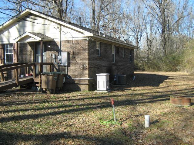 view of home's exterior featuring a lawn and cooling unit