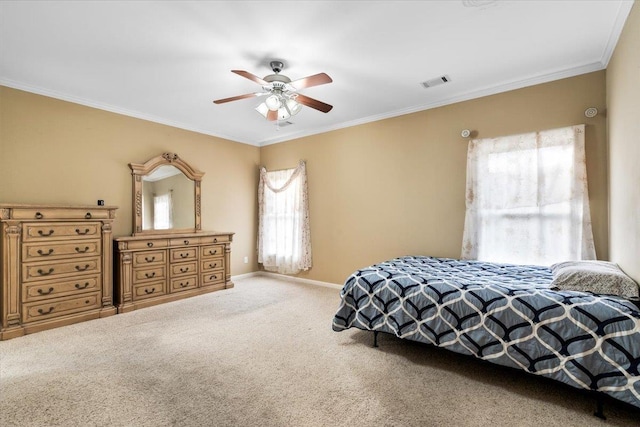 carpeted bedroom featuring ceiling fan and crown molding