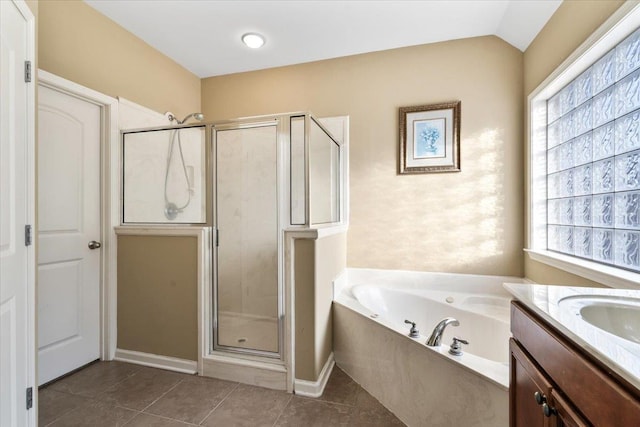 bathroom featuring separate shower and tub, vanity, vaulted ceiling, and a wealth of natural light