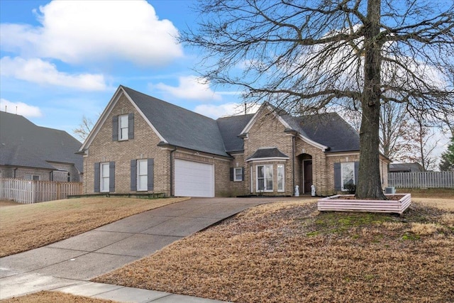 view of front of property featuring a front yard and a garage