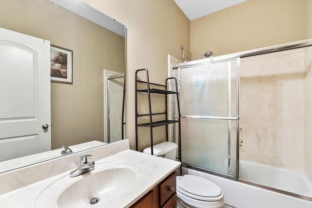 full bathroom with toilet, bath / shower combo with glass door, and vanity