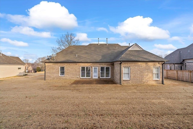 rear view of property featuring a yard