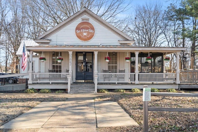 country-style home featuring covered porch and french doors