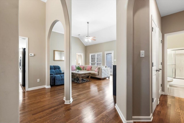 hall with dark hardwood / wood-style flooring and lofted ceiling