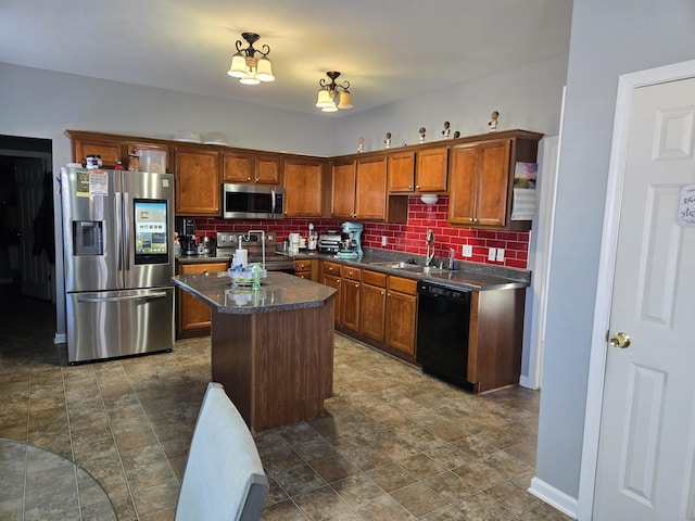 kitchen featuring tasteful backsplash, sink, stainless steel appliances, and a center island