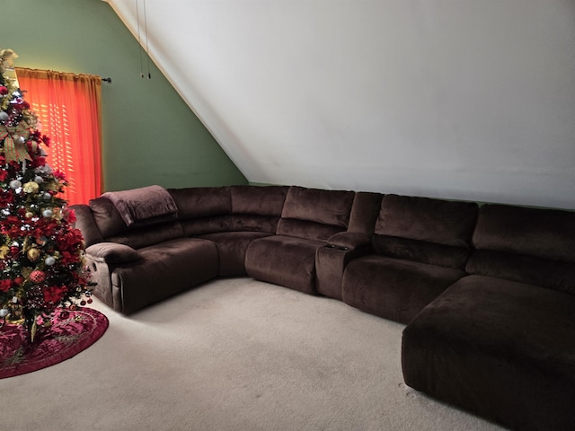 living room featuring lofted ceiling and carpet flooring