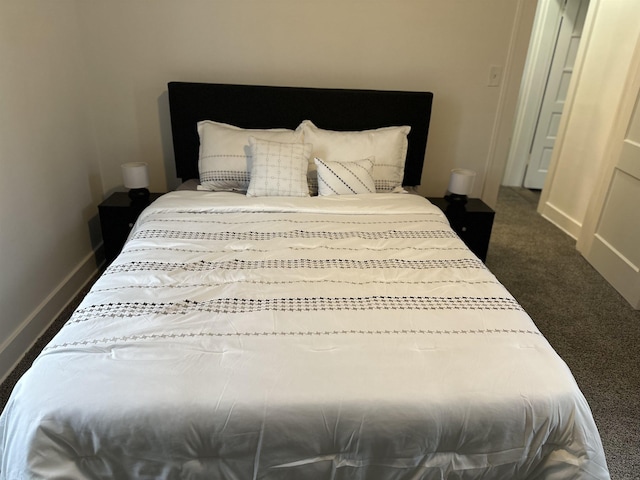 bedroom featuring dark carpet