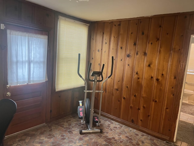 workout area featuring wood walls