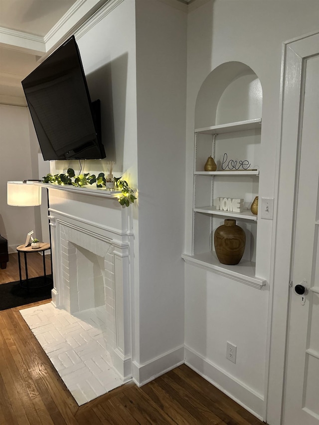 unfurnished living room with dark hardwood / wood-style flooring and ornamental molding