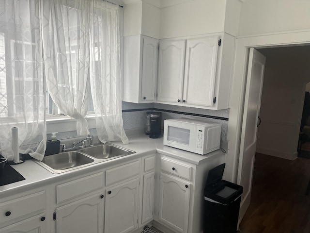 kitchen featuring sink and white cabinetry