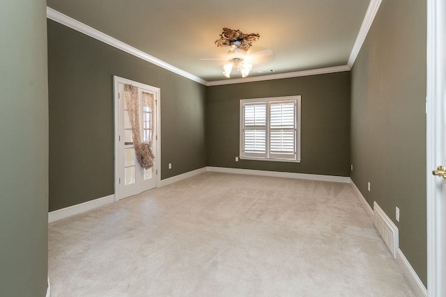 carpeted empty room with ceiling fan and ornamental molding