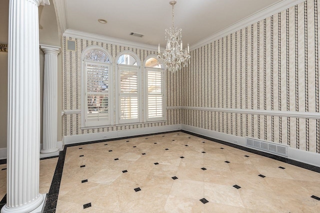 unfurnished dining area with a notable chandelier, crown molding, and ornate columns