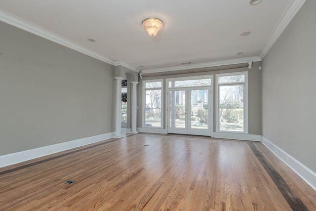 unfurnished room with french doors, crown molding, and hardwood / wood-style flooring