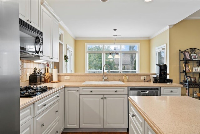 kitchen with sink, white cabinets, and gas stovetop