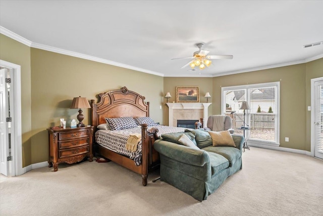 bedroom featuring light carpet, ceiling fan, ornamental molding, and a tiled fireplace