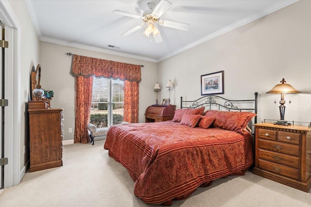 carpeted bedroom with ceiling fan and ornamental molding