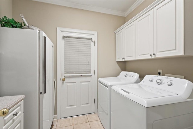 washroom with cabinets, separate washer and dryer, ornamental molding, and light tile patterned floors