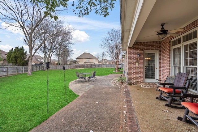 view of yard featuring ceiling fan and a patio area