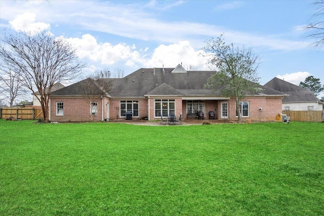 rear view of property featuring a patio area and a yard