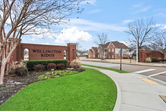 community sign featuring a lawn