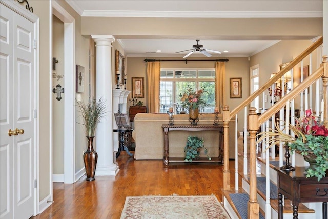 foyer entrance featuring ceiling fan, ornamental molding, hardwood / wood-style flooring, and decorative columns