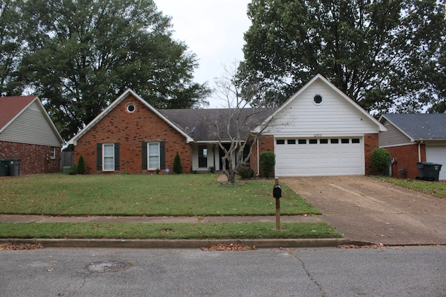 view of front of house featuring a front yard and a garage