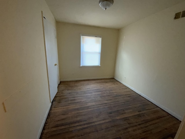 unfurnished room with dark hardwood / wood-style floors