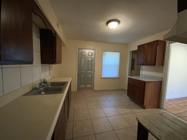 kitchen featuring light tile patterned floors and sink