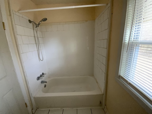 bathroom with tile patterned flooring, a healthy amount of sunlight, and shower / washtub combination