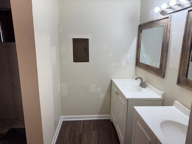 bathroom with vanity, electric panel, and hardwood / wood-style floors