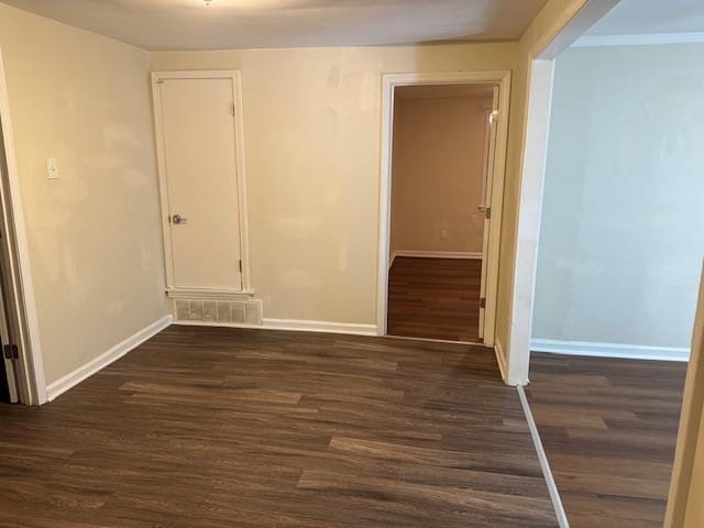 spare room featuring dark wood-type flooring