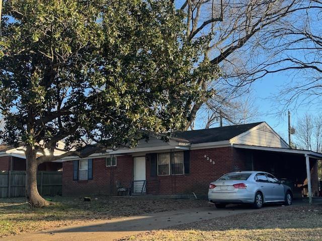 single story home featuring a carport