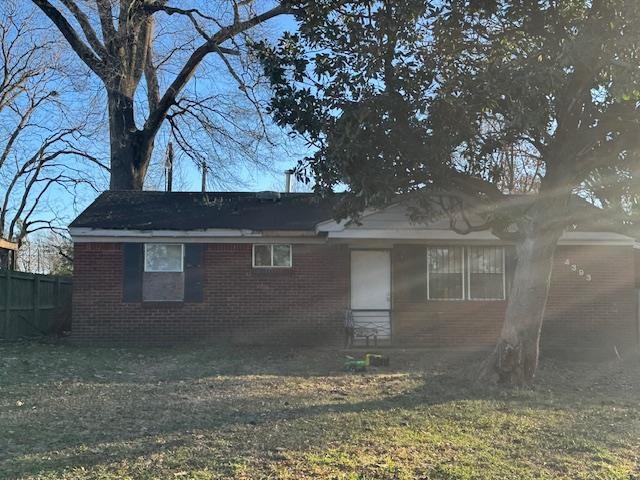 back of house with a lawn