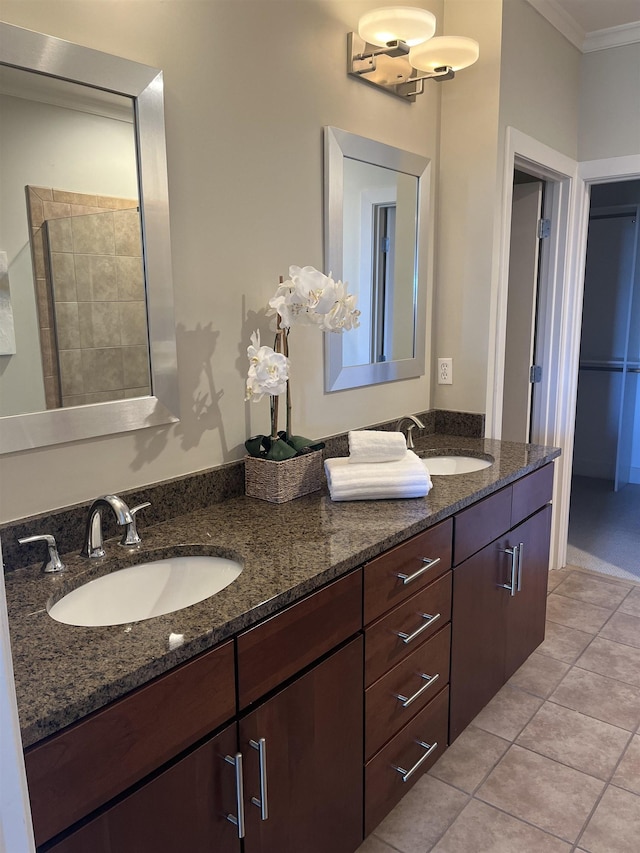 bathroom featuring walk in shower, vanity, tile patterned flooring, and ornamental molding