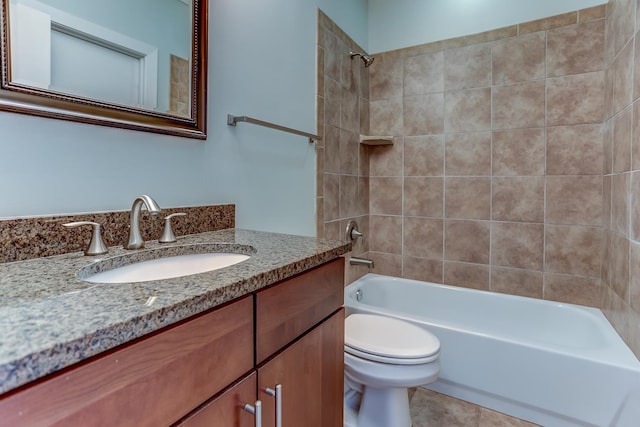 full bathroom with toilet, tile patterned flooring, tiled shower / bath, and vanity