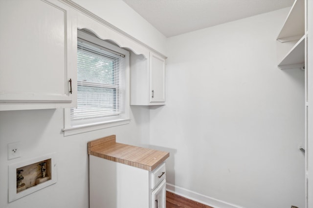 clothes washing area featuring cabinets, dark hardwood / wood-style floors, and hookup for a washing machine