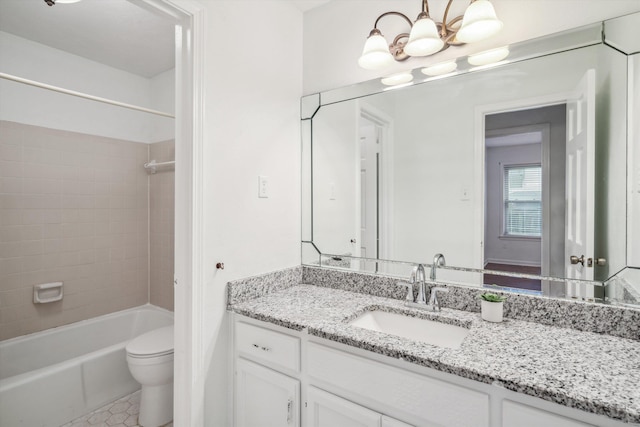 full bathroom featuring toilet, tiled shower / bath, vanity, a notable chandelier, and tile patterned floors