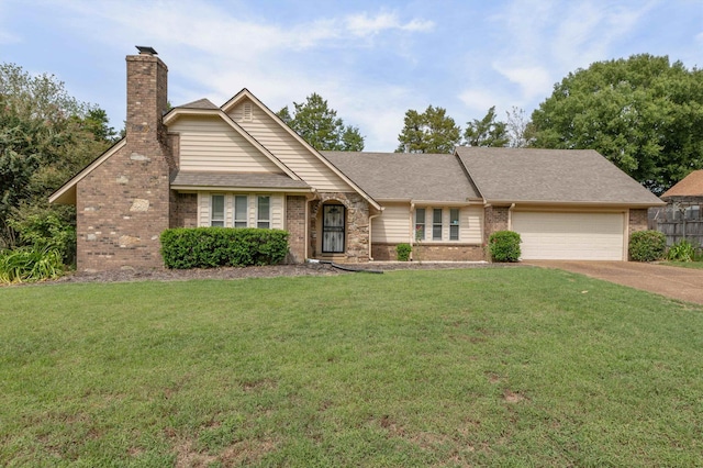 view of front of home with a front yard and a garage