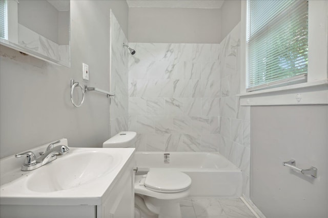 full bathroom with toilet, vanity, and tiled shower / bath